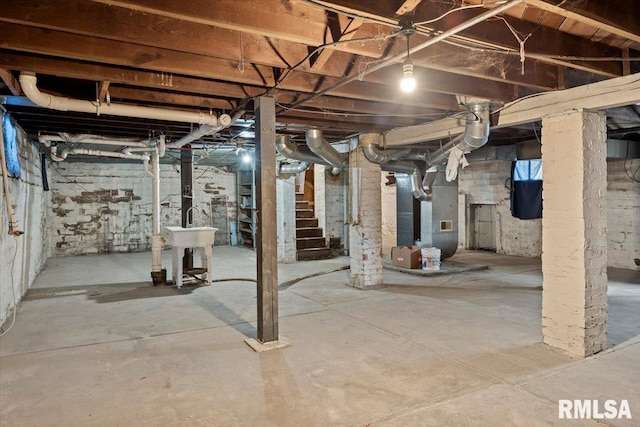 unfinished below grade area with stairs and heating unit