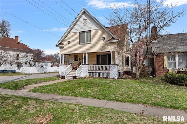 victorian home with a front lawn and a porch