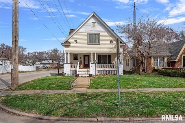 victorian house featuring fence, a front lawn, and a porch