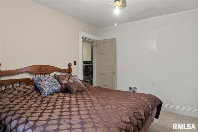 carpeted bedroom with baseboards and visible vents