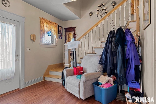 entrance foyer with baseboards, stairway, and wood finished floors