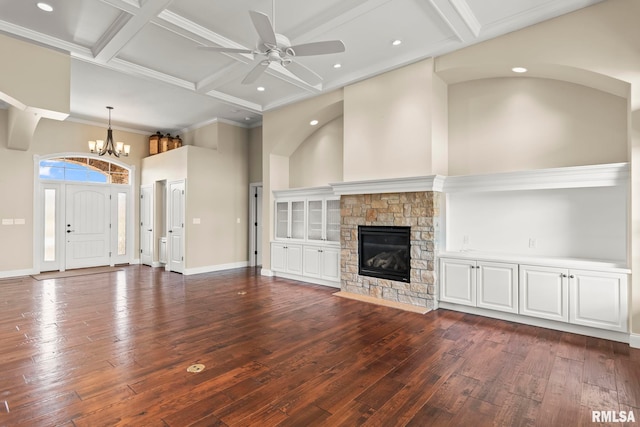 unfurnished living room with baseboards, dark wood-style floors, coffered ceiling, and ceiling fan with notable chandelier