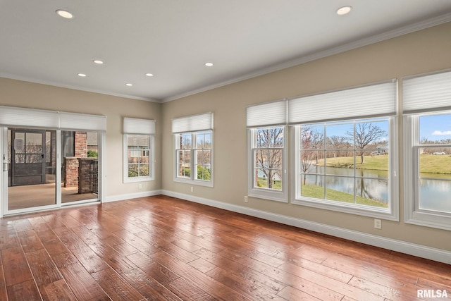unfurnished room with baseboards, ornamental molding, recessed lighting, and hardwood / wood-style flooring
