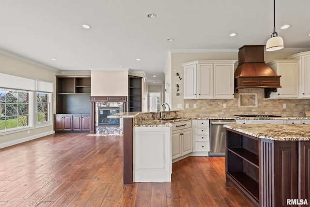 kitchen featuring open shelves, custom range hood, stainless steel appliances, a sink, and a peninsula