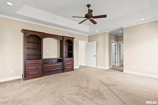 unfurnished living room featuring visible vents, carpet, baseboards, a ceiling fan, and a raised ceiling