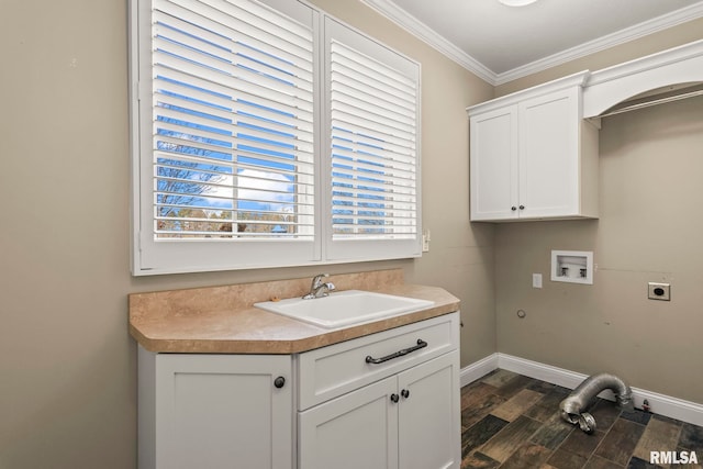 clothes washing area featuring ornamental molding, a sink, cabinet space, electric dryer hookup, and washer hookup