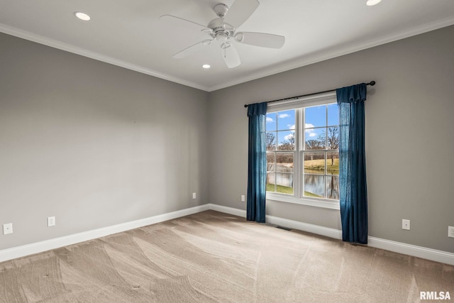 carpeted spare room featuring a ceiling fan, baseboards, visible vents, ornamental molding, and recessed lighting