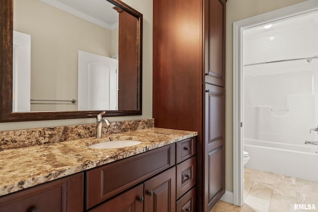 bathroom with toilet, vanity, ornamental molding, and  shower combination