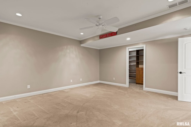 empty room featuring visible vents, crown molding, baseboards, a ceiling fan, and light colored carpet