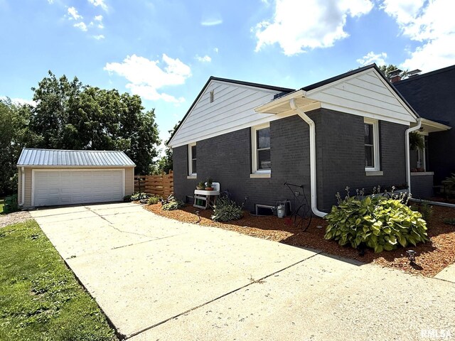 308 Galesburg Rd, Knoxville, IL 61448 - view of side of home with an outdoor structure and brick siding