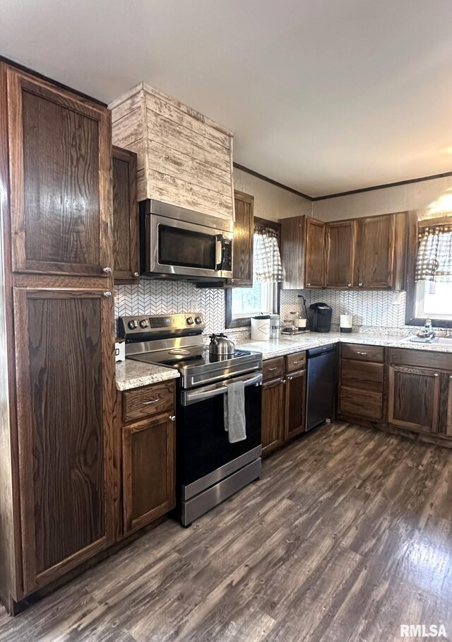 308 Galesburg Rd, Knoxville, IL 61448 - kitchen with appliances with stainless steel finishes, plenty of natural light, backsplash, dark wood-style flooring, and crown molding