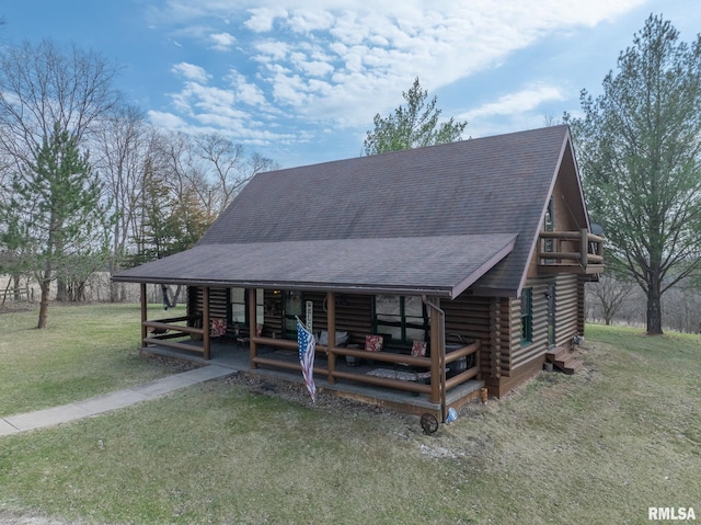 log cabin featuring a front yard, roof with shingles, and log exterior