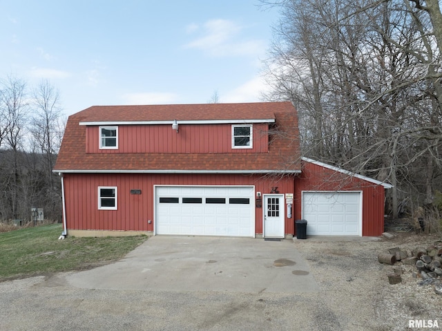exterior space with an outbuilding and roof with shingles