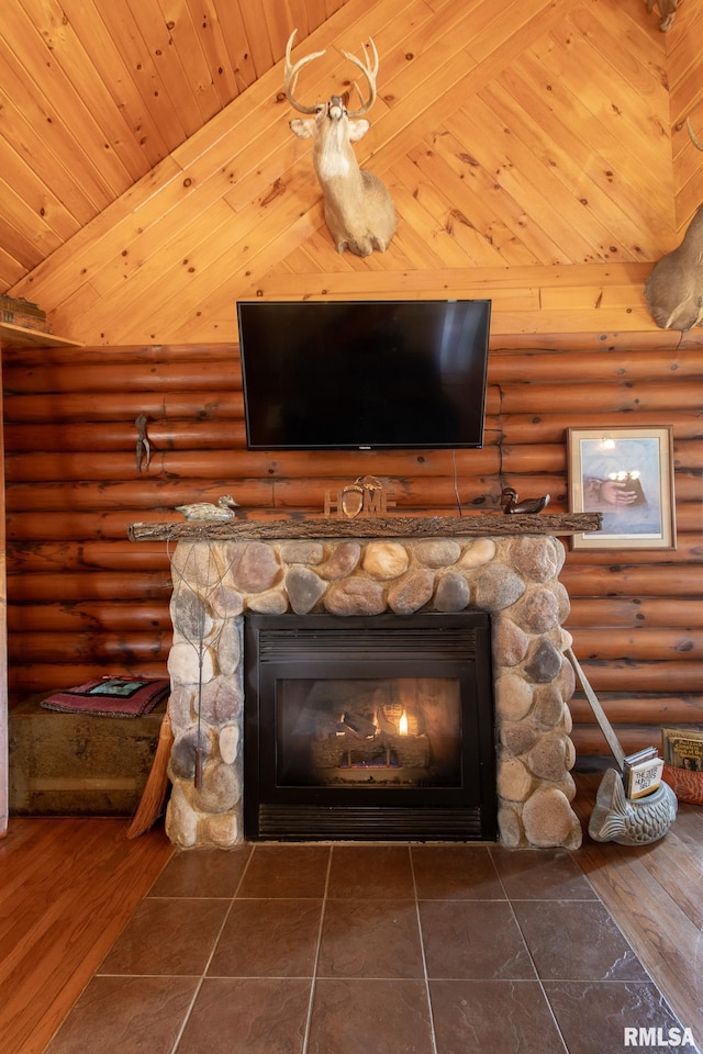 interior details featuring log walls, wood finished floors, wooden ceiling, and a stone fireplace