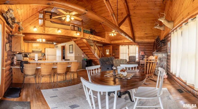 dining room with high vaulted ceiling, visible vents, ceiling fan, stairway, and light wood-type flooring