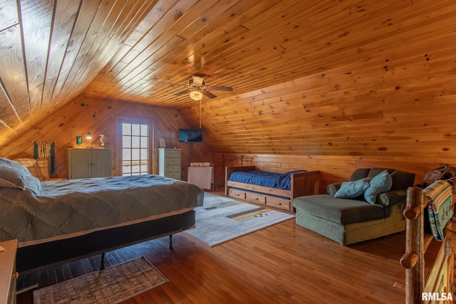 bedroom with wooden walls, wood finished floors, a ceiling fan, vaulted ceiling, and wood ceiling