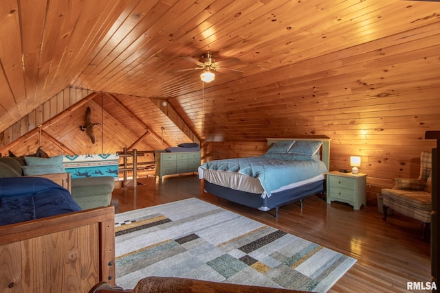 bedroom with wooden ceiling, hardwood / wood-style flooring, wooden walls, and vaulted ceiling