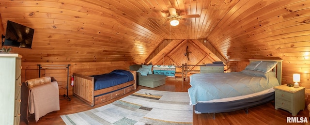 bedroom with lofted ceiling, wood walls, wood ceiling, and wood finished floors