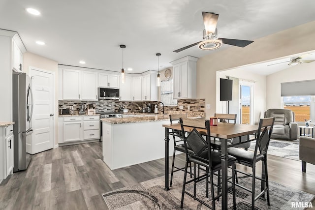 413 Hodges Ct, Chatham, IL 62629 - kitchen with light stone countertops, appliances with stainless steel finishes, and ceiling fan