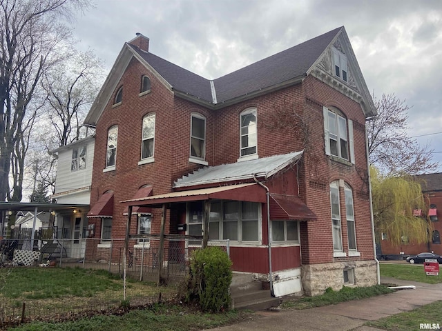view of front of home featuring a chimney, a porch, and brick siding