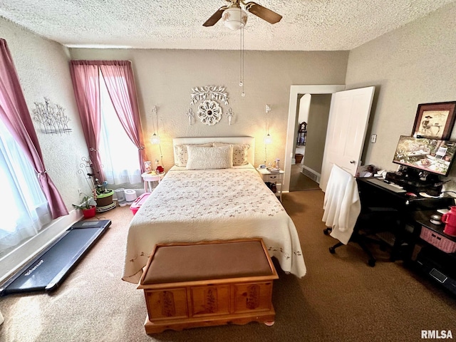 bedroom with carpet flooring, a textured ceiling, and a textured wall