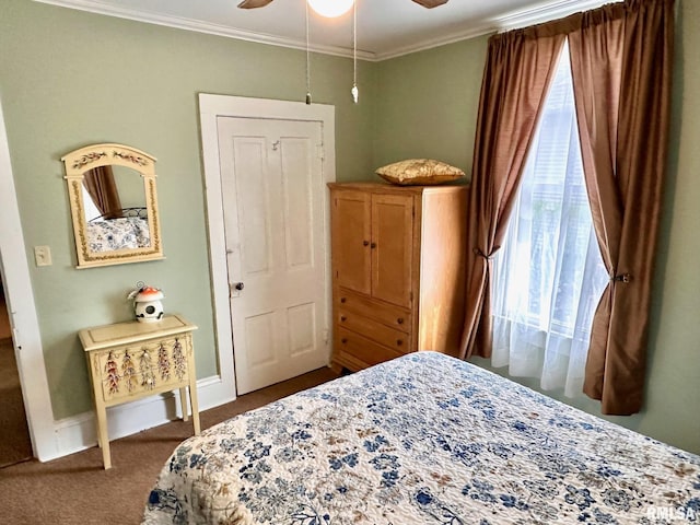 bedroom featuring a ceiling fan, ornamental molding, baseboards, and dark colored carpet