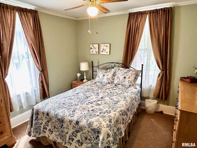 bedroom with baseboards, ornamental molding, multiple windows, and carpet