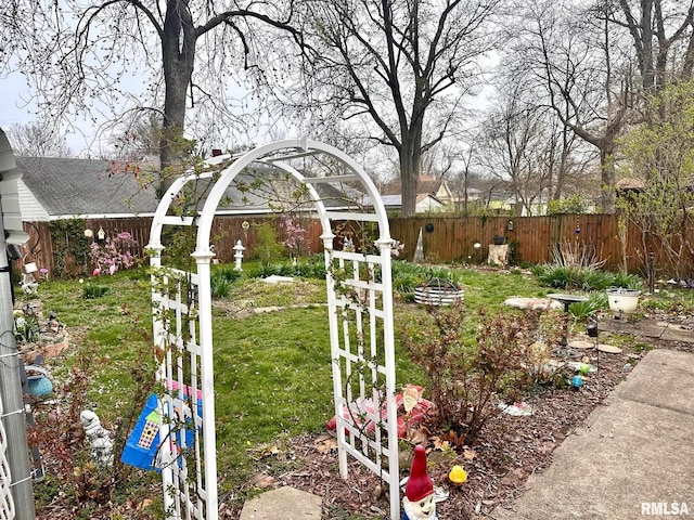 view of yard featuring fence and an outdoor fire pit
