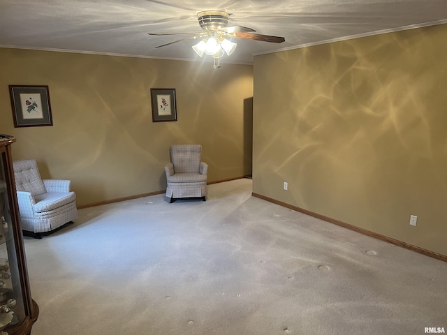 unfurnished room featuring carpet floors, crown molding, baseboards, and ceiling fan