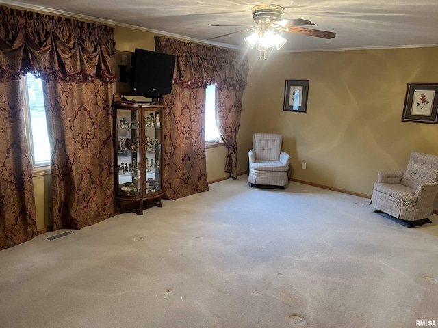 unfurnished room featuring a wealth of natural light, visible vents, ornamental molding, and a ceiling fan