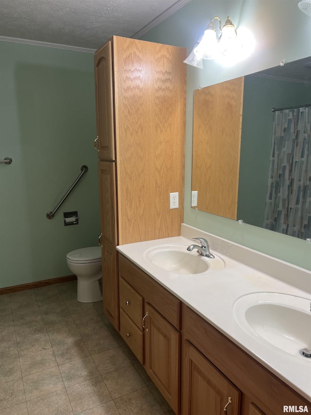 full bathroom featuring double vanity, toilet, a sink, and a textured ceiling