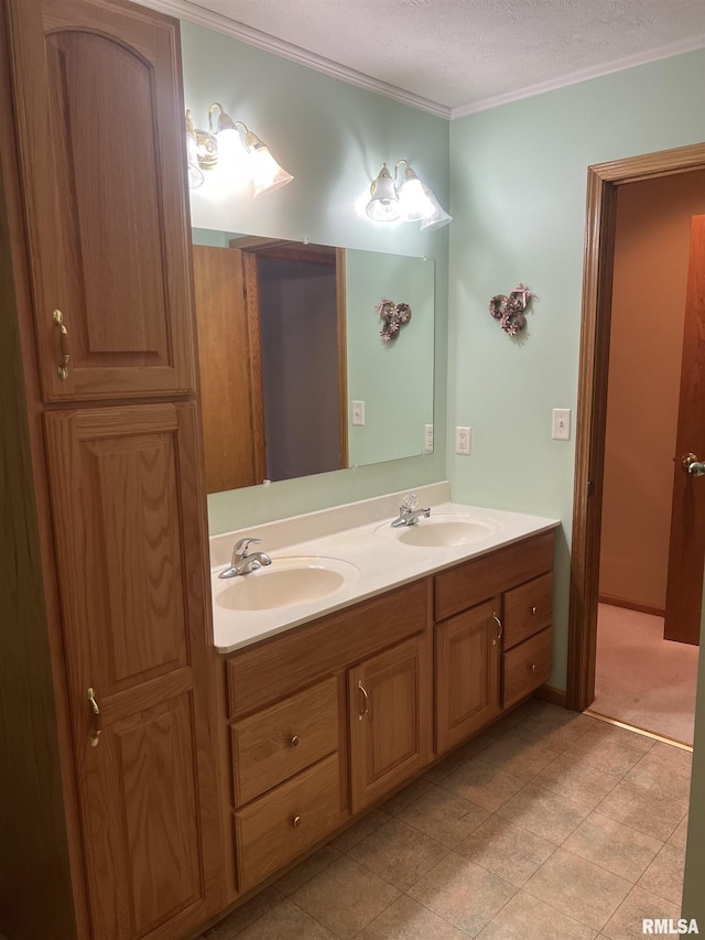 full bath featuring double vanity, crown molding, and a sink
