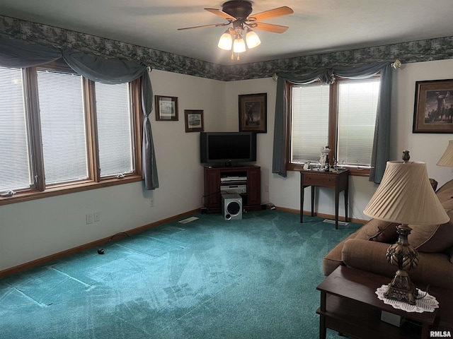carpeted living room featuring baseboards, visible vents, and a ceiling fan