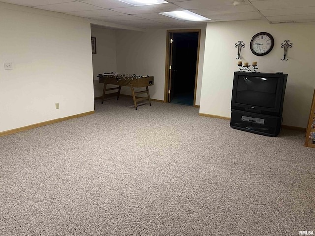 interior space featuring baseboards and a drop ceiling