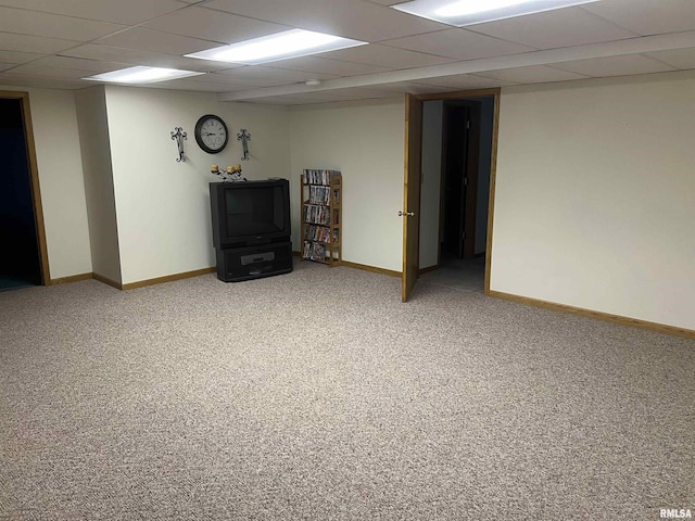 finished basement featuring baseboards, carpet flooring, and a drop ceiling