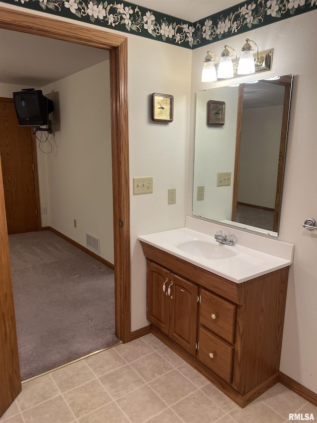 bathroom featuring baseboards, visible vents, and vanity