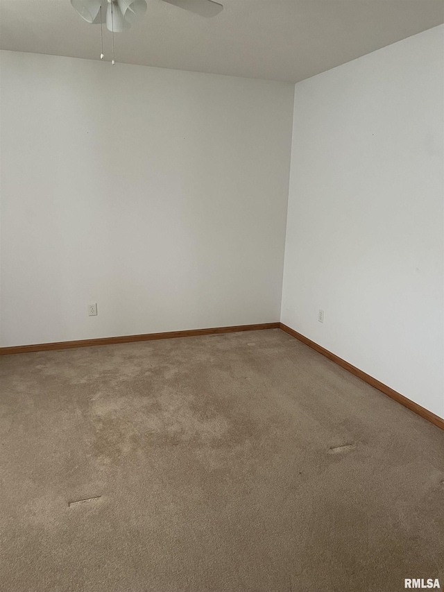 unfurnished room with baseboards, ceiling fan, and carpet flooring