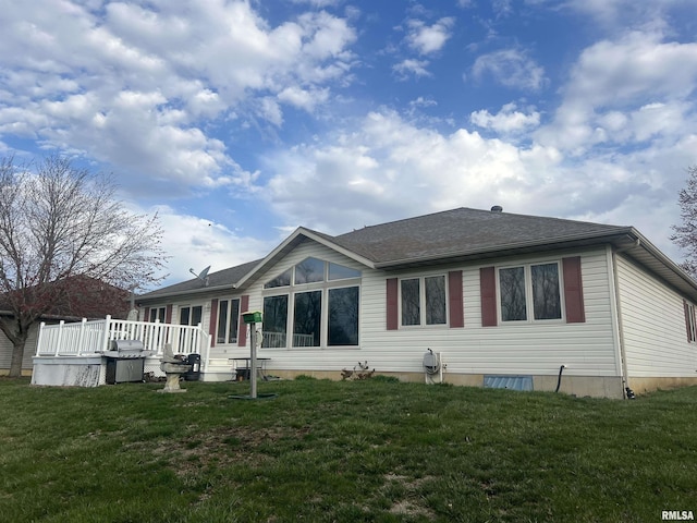 rear view of property featuring a deck and a yard