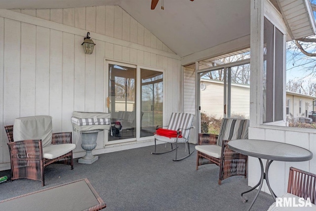 sunroom / solarium featuring a ceiling fan and a wealth of natural light