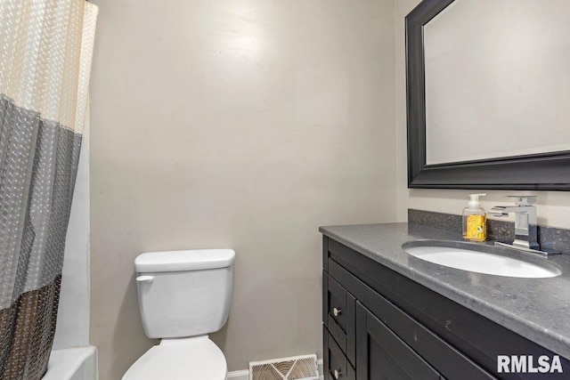 bathroom with vanity, visible vents, and toilet