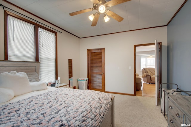 214 N Ohio St, Camp Point, IL 62320 - bedroom featuring a closet, baseboards, ornamental molding, a ceiling fan, and light carpet