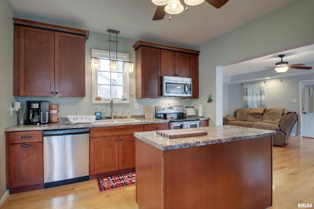 214 N Ohio St, Camp Point, IL 62320 - kitchen featuring a sink, light wood-style flooring, appliances with stainless steel finishes, and a ceiling fan