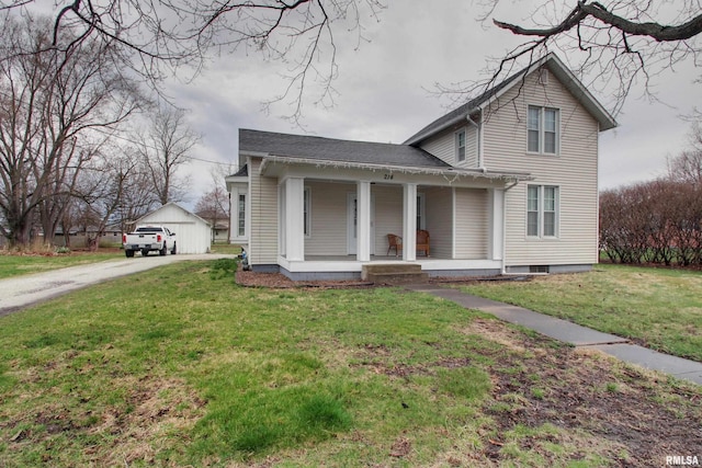 214 N Ohio St, Camp Point, IL 62320 - view of front of house featuring concrete driveway, an outdoor structure, a front lawn, a shingled roof, and a porch