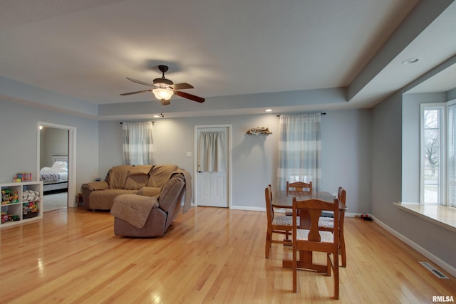 214 N Ohio St, Camp Point, IL 62320 - living area with a raised ceiling, a ceiling fan, light wood-style flooring, baseboards, and visible vents