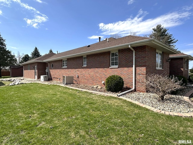 290 W Railroad St, Roseville, IL 61473 - back of house featuring brick siding, central AC, and a yard