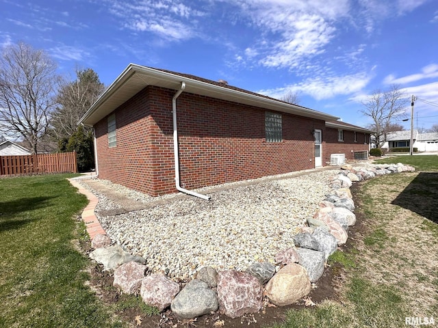 290 W Railroad St, Roseville, IL 61473 - view of home's exterior with cooling unit, a yard, brick siding, and fence