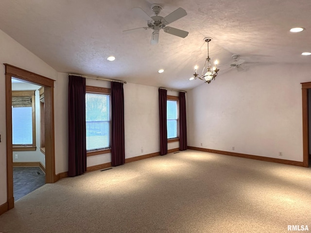 290 W Railroad St, Roseville, IL 61473 - spare room with light carpet, ceiling fan with notable chandelier, lofted ceiling, and baseboards