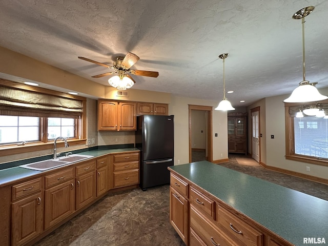 290 W Railroad St, Roseville, IL 61473 - kitchen with freestanding refrigerator, a sink, dark countertops, and brown cabinetry