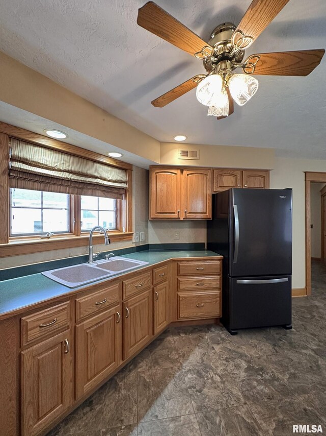 290 W Railroad St, Roseville, IL 61473 - kitchen featuring a sink, ceiling fan, freestanding refrigerator, visible vents, and brown cabinetry