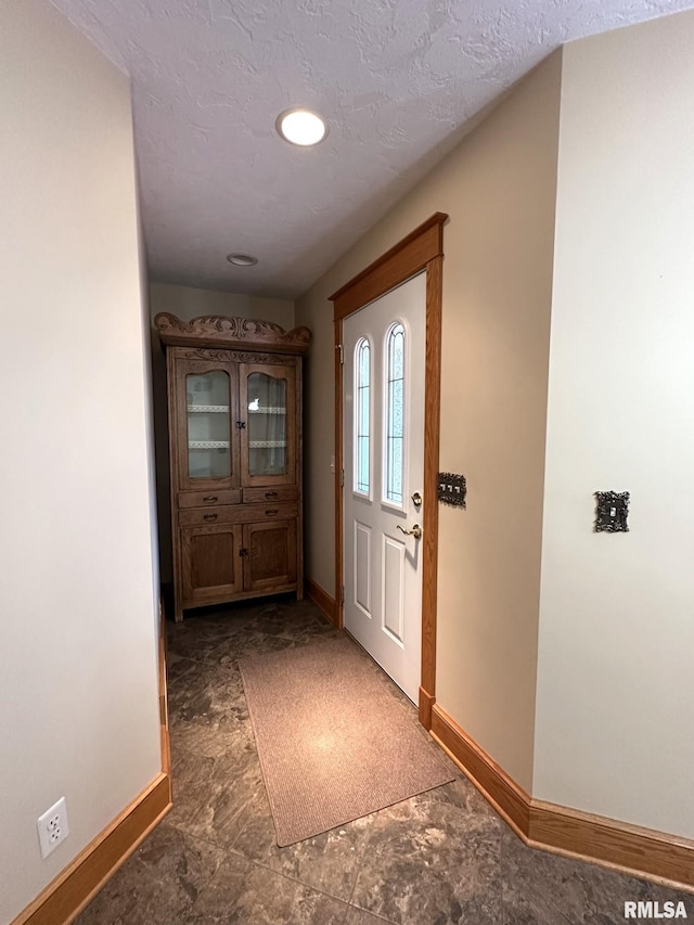 290 W Railroad St, Roseville, IL 61473 - doorway to outside featuring baseboards and a textured ceiling